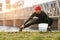 Athletic man doing stretching exercises, outdoor. Active male working out outside on the background of the bridge