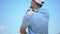 Athletic man playing golf, suffering terrible pain in shoulder, sport and health