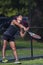 An athletic man playing tennis at a local court