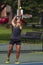 An athletic man playing tennis at a local court