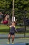 An athletic man playing tennis at a local court