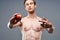 athletic man with a pumped-up torso and a tattoo on his arm red apple health