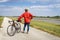 athletic man is riding a gravel touring bike - biking on a levee trail along Chain of Rocks Canal