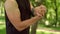 Athletic man stretching hands. Guy warm up wrist in park. Fit boy training