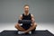 Athletic man using a foam roller to relieve sore muscles after a workout.