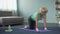Athletic mature woman practicing yoga poses at home, fitness and health