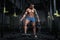 Athletic pumped man bodybuilder with chain in hall of crossfit