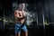 Athletic pumped man bodybuilder slaps magnesia in gym