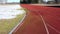 Athletic Running track in old stadium with snow in early spring, aerial