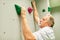 Athletic senior climbing in a climbing gym