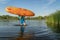 Athletic, senior man is launching a prone kayak