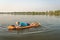 Athletic, senior man is paddling a prone kayak