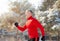 Athletic senior man in sportswear running at winter park, side view. Seasonal sports and tempering concept