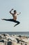 athletic shirtless dancer jumping over