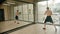 An athletic shirtless man standing in the studio and training his boxing in front of the mirror