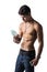 Athletic shirtless young man holding protein shake