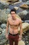 Athletic shirtless young man outdoor at river or water stream