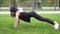 An athletic slender woman trains, does fitness and does plank exercise