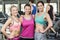 Athletic smiling women posing with hands on hips