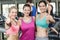 Athletic smiling women posing with thumbs up