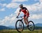 Athletic sportsman cyclist in professional sportswear and helmet riding cross country bike