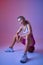 Athletic sportswoman sitting on ball in studio