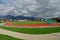 Athletic stadium in a city in Eastern Europe. On the background there are mountains covered by forests.