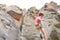 Athletic strong man climbing a rock wall - Climber training and performing on a canyon mountain