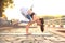 Athletic strong woman practicing difficult yoga pose outdoors