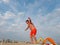 Athletic teenager on the beach gymnastic exercises