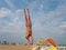 Athletic teenager on the beach gymnastic exercises