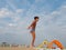 Athletic teenager on the beach gymnastic exercises