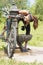 Athletic woman with bike drinking water after exercise, outdoor.