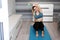 Athletic woman doing dumbbells workout exercise at home