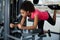 Athletic woman doing exercise for legs and buttocks on press machine at gym