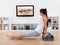 Athletic woman doing exercises in her livingroom