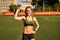 Athletic woman doing strength workout with kettlebell outdoor