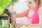 Athletic woman holds a yogurt on the table