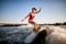 Athletic woman masterfully rides the wave on surfboard