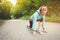 Athletic woman running in countryside road. Fitness female runner in ready start line pose outdoors in summer sprint