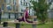 Athletic woman sits on a twine on the bench in the yard of an apartment building, fitness in the urban environment, yoga