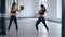 Athletic Woman Trains Her Kicks on a Punching Bag that Her Partner Holds. Training of Taekwondo or Kickboxing. Two