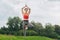 Athletic woman wearing bright red sport top doing yoga