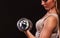 Athletic woman working with heavy dumbbells