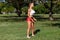 Athletic woman workout with resistance band outdoors. Fitness girl doing exercise for biceps at the park