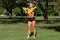 Athletic woman workout with resistance band outdoors. Fitness girl doing exercise for shoulders at the park