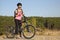 Athletic young girl on a bicycle in tourist trip