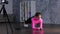 Athletic young lady in sportswear having workout while training at home, using smartphone and recording video on the