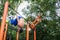 Athletic young man doing skin the cat exercise during advanced workout