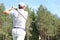 Athletic young man playing golf in golfclub